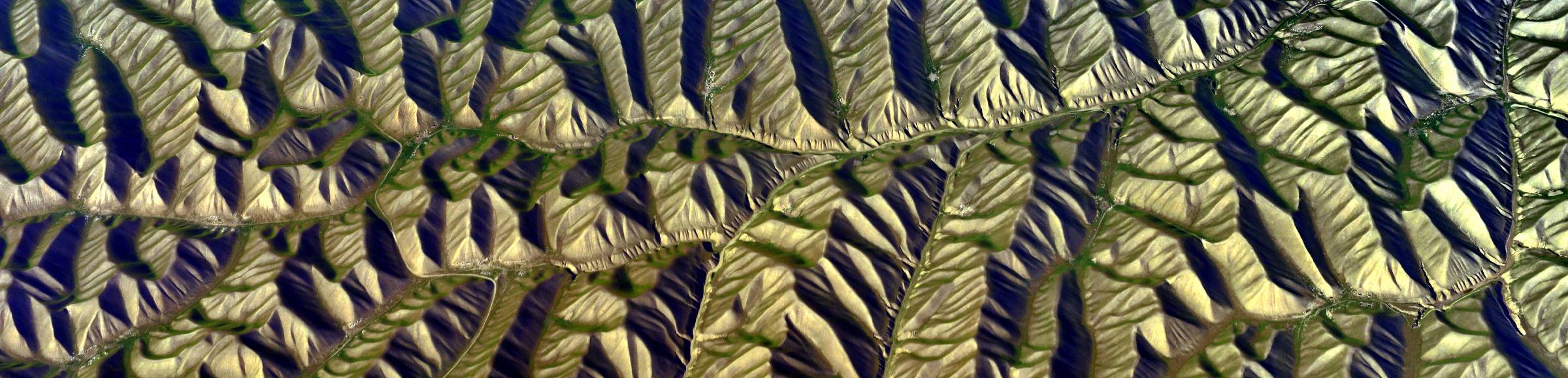 Valley landscape surrounded by mountains with low mountain range structure in Aselma in Faryab, Afghanistan
