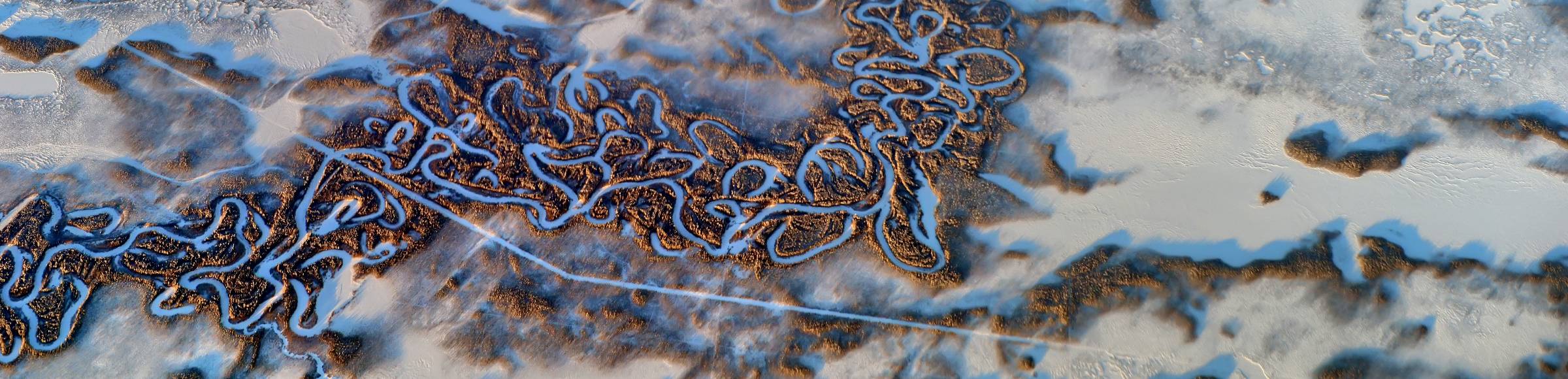 Wintry snowy meandering, serpentine curve of river 