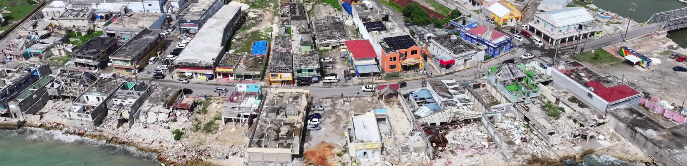 Damage situation of the infrastructure destroyed by the flood disaster as a landscape of ruins and debris on street Crane Road in Black River in St. Elizabeth Parish, Jamaica